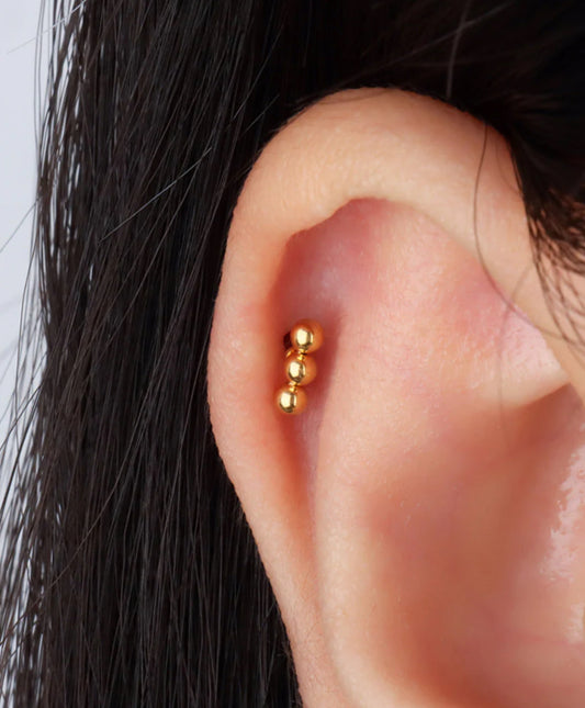 Gold stainless steel stud earring, hypoallergenic, minimalist design on ear