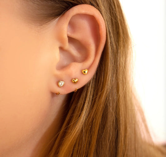 Sleek stainless steel huggie hoops for sensitive ears — timeless design.