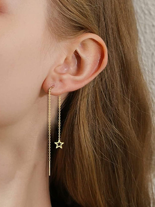 A pair of gold-colored stainless steel earrings with star-shaped embellishments at the end of each strand in ear