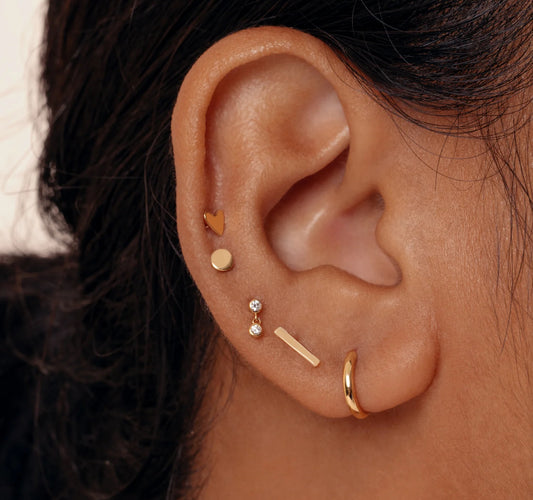 A stud earring with a gold-colored