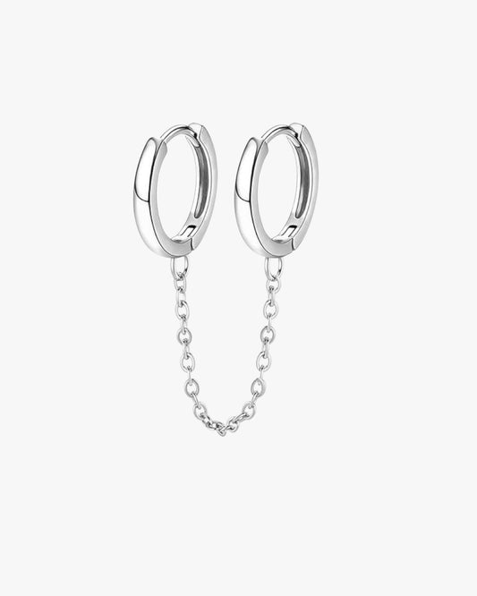 Pair of silver hoop earrings with a chain on a white background