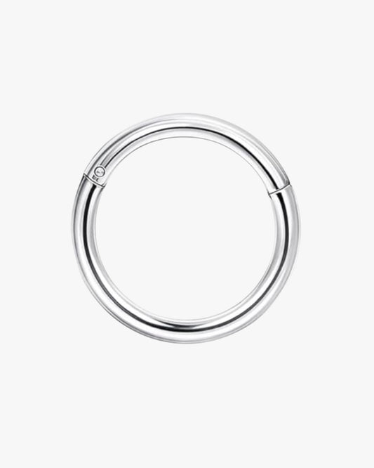 A silver-colored stainless steel hoop earring with a closed circular shape and a small ring at the top.