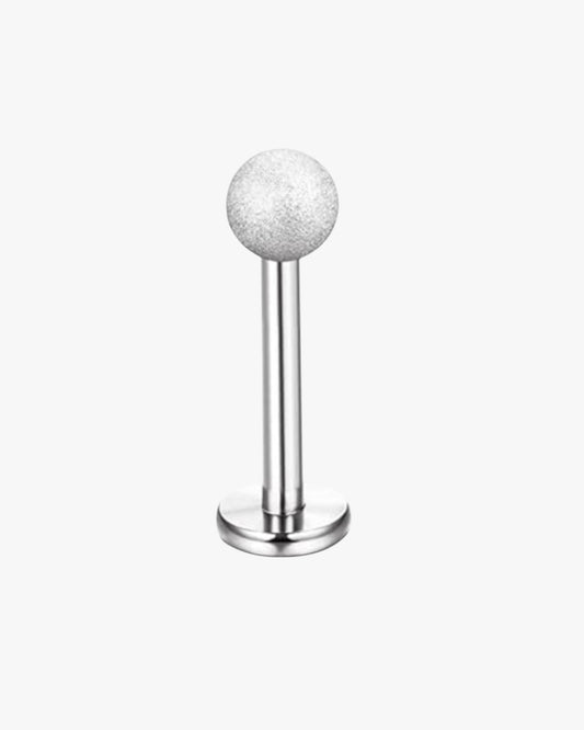 A single silver-colored stud earring with a textured surface, designed for piercing.