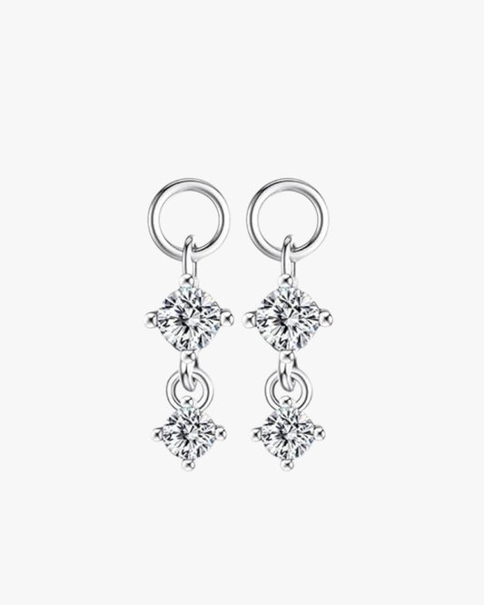 A pair of sterling silver hoop earrings with gold plating and multiple diamond-like stones set within the hoops.