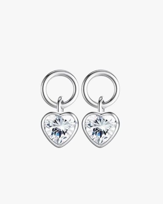 A pair of silver-colored sterling silver earrings with a heart-shaped diamond in the center, displayed against a white background.