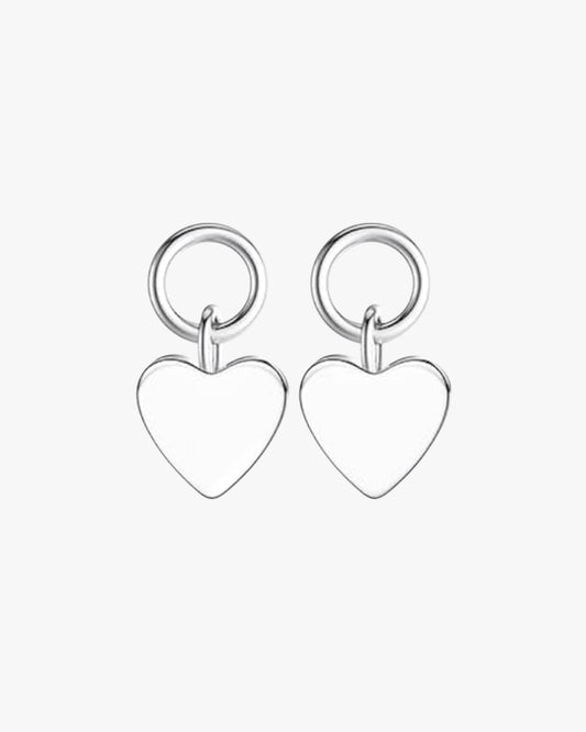 A pair of silver-colored heart-shaped earrings