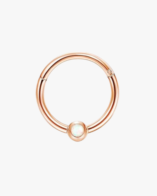 A rose gold-colored stainless steel hoop with a single central bead.