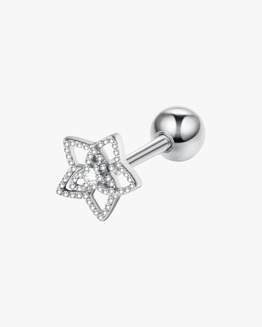 A single silver-colored stud earring with a geometric star design and a small diamond-like sparkle in the center.