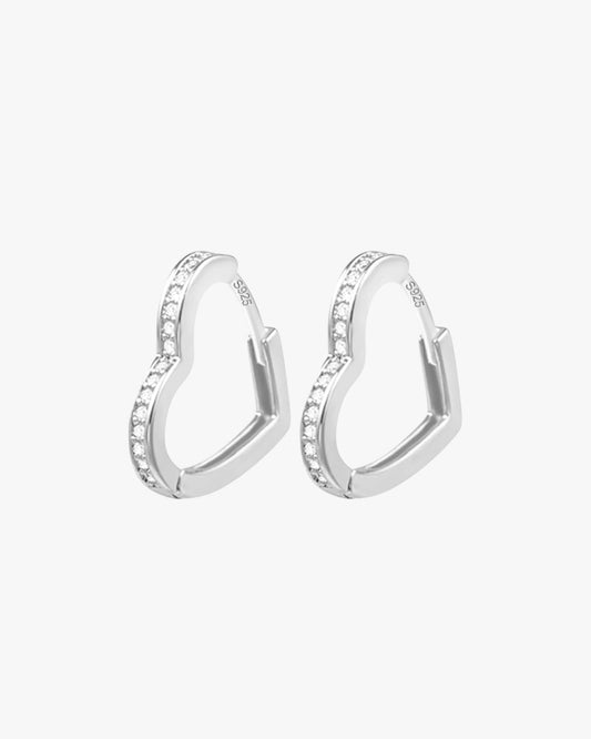 A pair of silver-colored hoop earrings with small, clear stones embedded along the hoop's length.