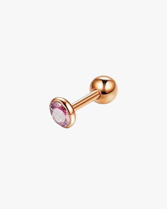 A stainless steel barbell with a pink gemstone in the center.