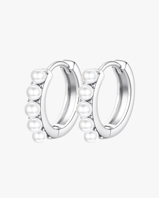 A pair of silver-colored hoop earrings with pearl accents