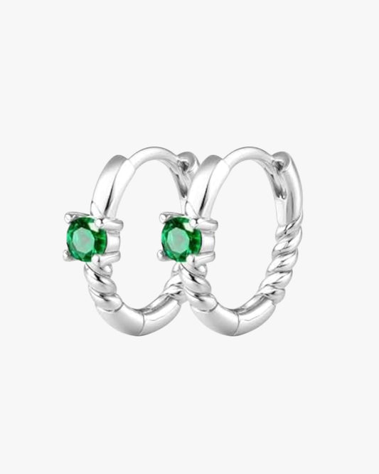 A pair of silver-colored hoop earrings with green gemstones, crafted from 14K gold plated stainless steel.