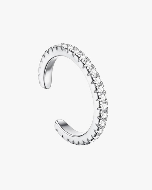 A silver color  cuff with a row of zirconia stones set in a cuff design, against a white background.
