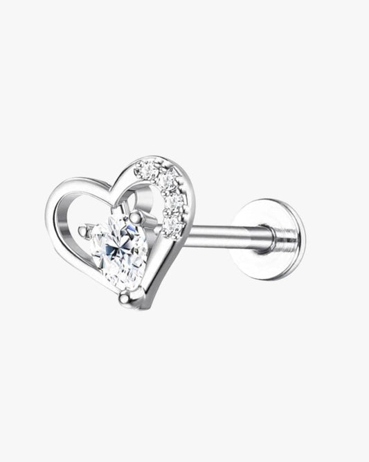 A silver-colored stainless steel stud earring with a heart-shaped design featuring a central cubic zirconia, surrounded by smaller clear crystals.