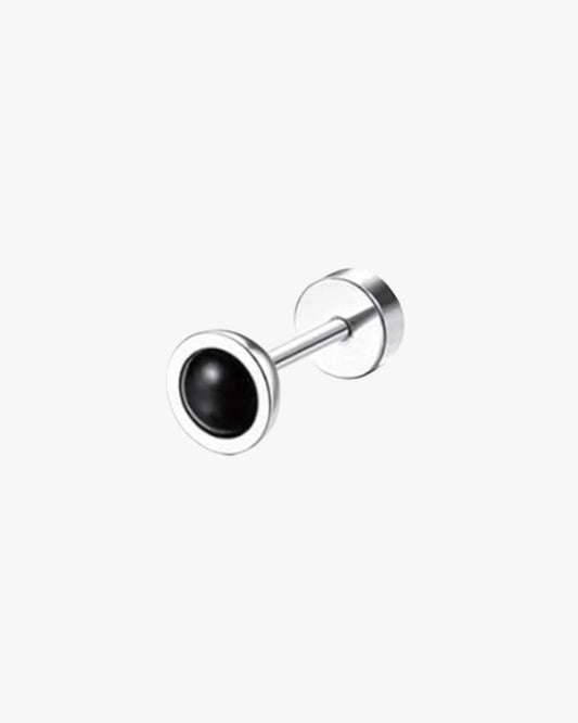 A single silver-colored stainless steel stud earring with a black circular detail on the end.