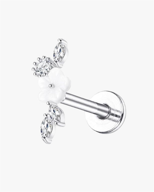A single silver-colored stud earring with a white flower-shaped design and small diamonds around it.