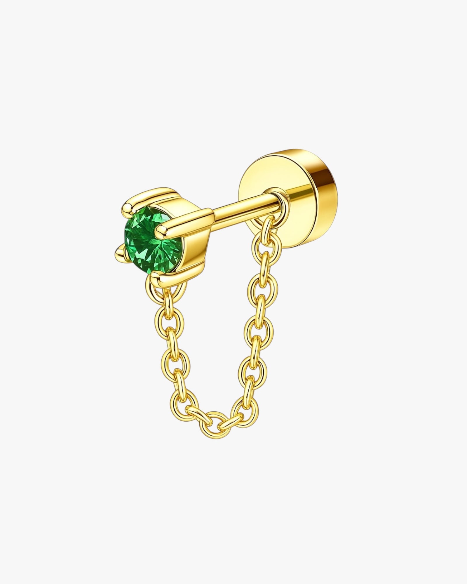 Gold earring with a green gemstone on a white background