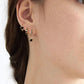 Gold-tone stainless steel hoops with smooth finish in ear