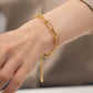 Gold bracelet on a wrist with a blurred background