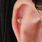 A gold-colored stainless steel heart-shaped stud with a small clear crystal in the center, attached to a gold-plated cap and bar.