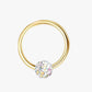 A gold-colored hoop earring with a multicolored gemstone in the center.