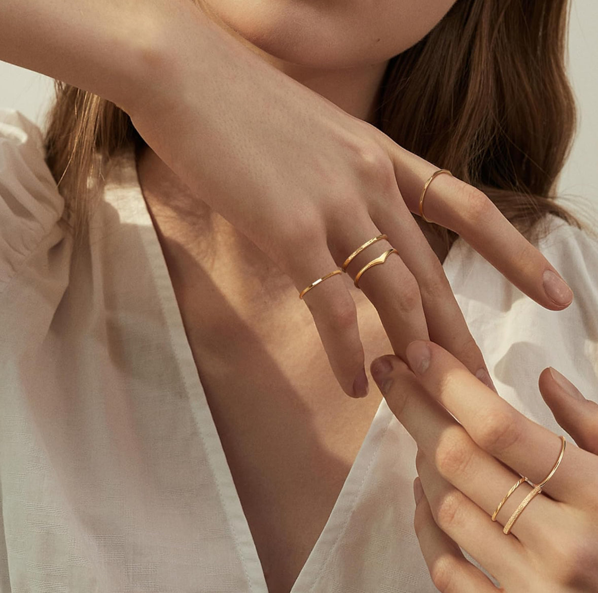 hand with styles stacked stainless stel rings