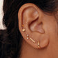 A stud earring with a gold-colored 