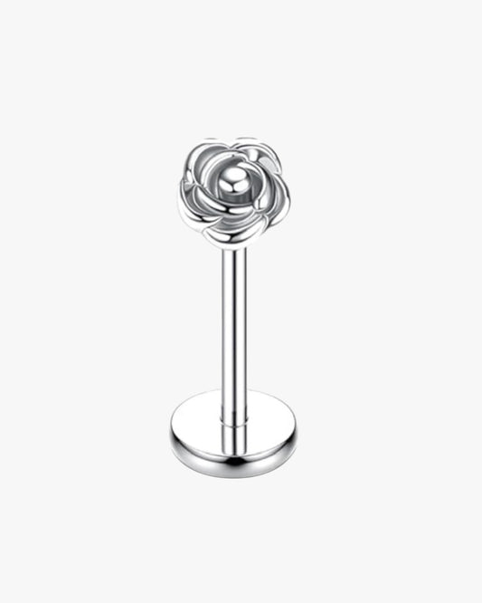 Silver rose-shaped earring on a white background