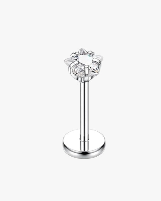 Silver lip ring with star-shaped gemstone on a white background