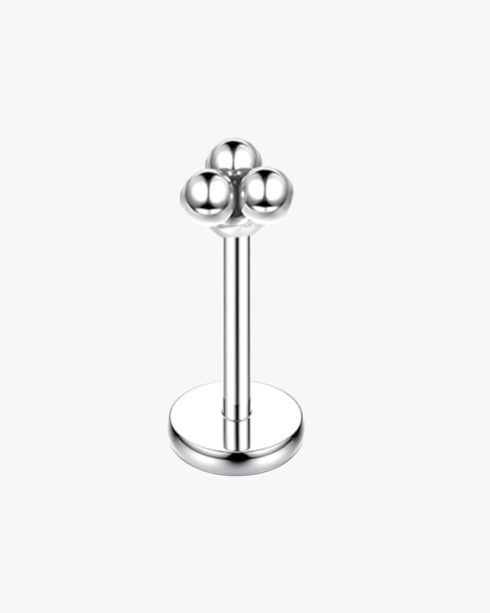Silver lip ring with three ball ends on a white background