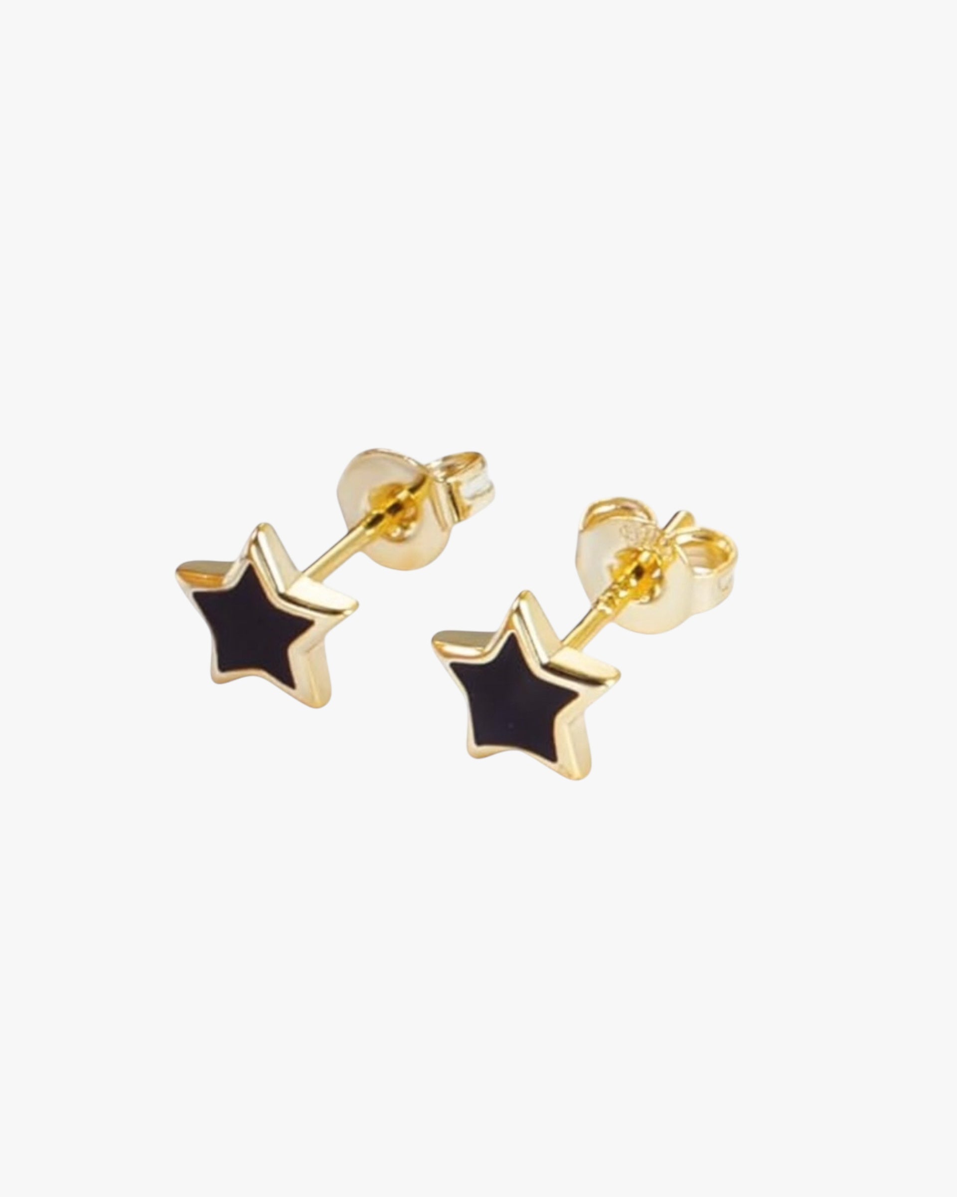 A pair of gold-colored earrings with a star silhouette design, crafted from sterling silver, against a white background.