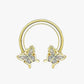 A gold-colored half hoop earring with a geometric pattern on the hoop and star-shaped embellishments on the ends.