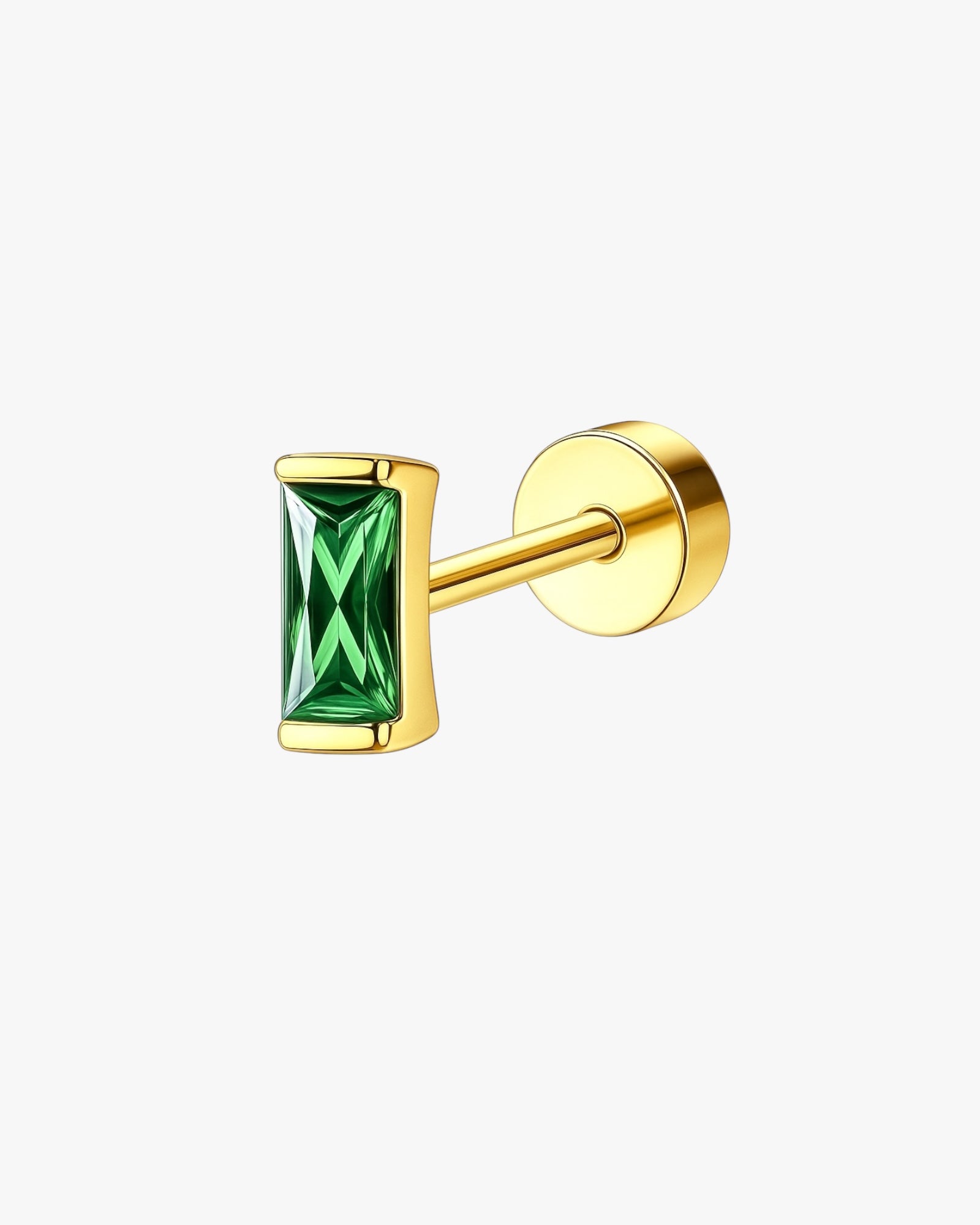 Gold earring with a green gemstone on a white background