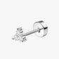 Silver earring with clear gemstones on a white background