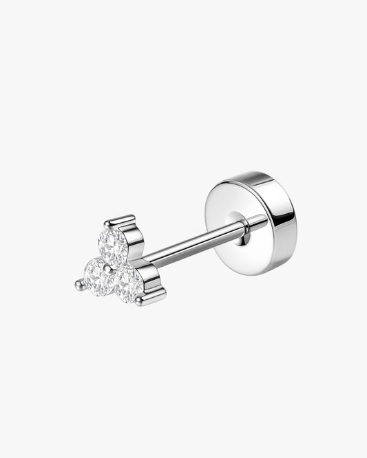 Silver earring with clear gemstones on a white background