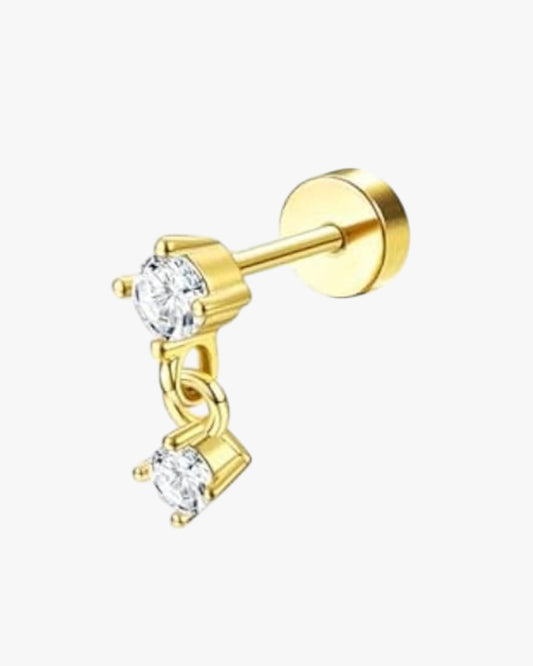 Gold earring with clear gemstones on a white background