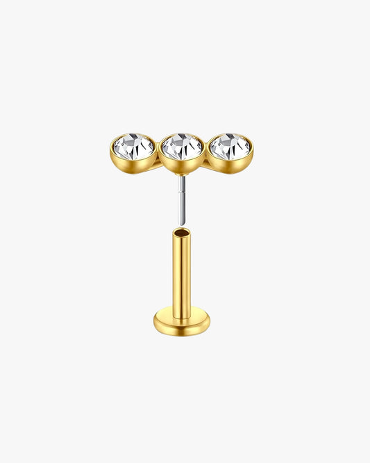 Gold nose ring with three clear gemstones on a white background