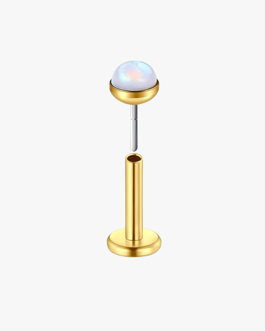 Gold-colored earring with opal on a white background