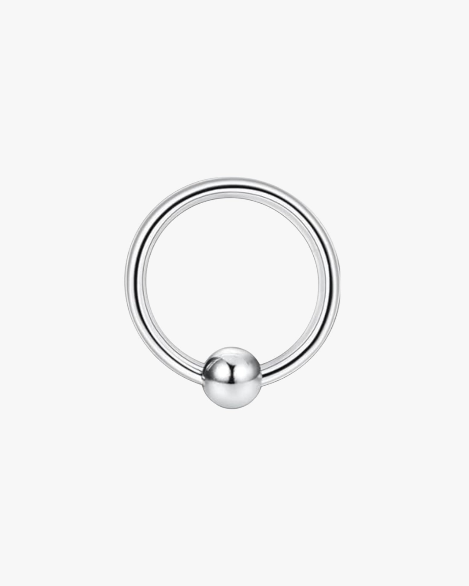 A silver-colored stainless steel clicker hoop with a smooth finish and a ball-shaped detail in the center.