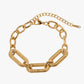 Gold stainless steel 18K PVD platen chain bracelet on a white background