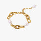 Gold stainless steel 18k pvd plated chain bracelet with pearls on a white background