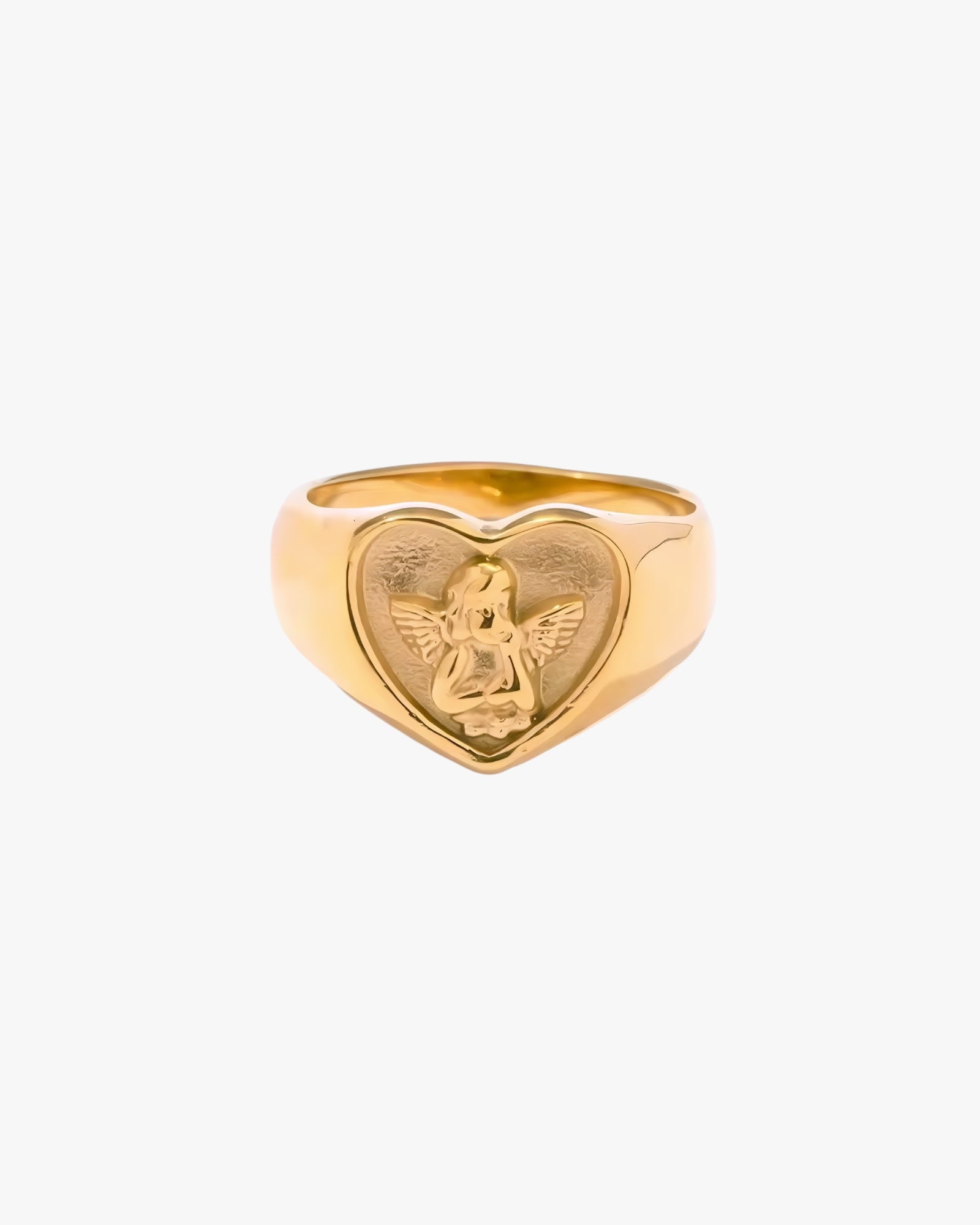 Gold heart-shaped ring with an engraved design on a white background