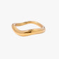 Gold stainless steel gold plated 18k PVD plated ring with a wavy design on a white background