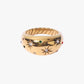 Gold stainless steel PVD 18K gold plated ring with star designs and gemstones on a white background