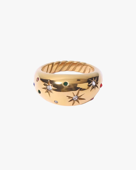 Gold stainless steel PVD 18K gold plated ring with star designs and gemstones on a white background