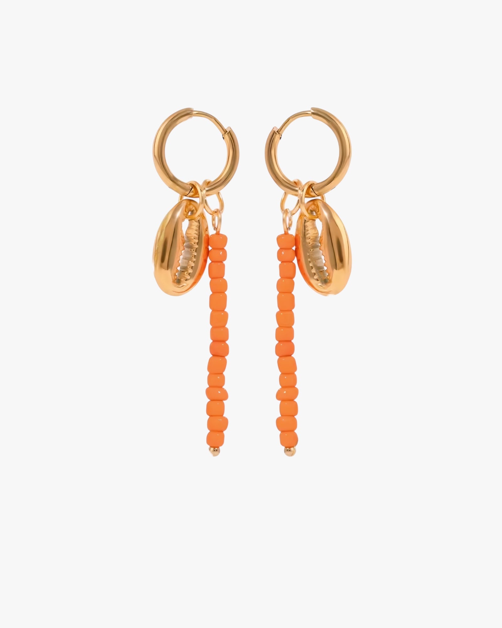 Gold hoop earrings with orange bead drops on a white background