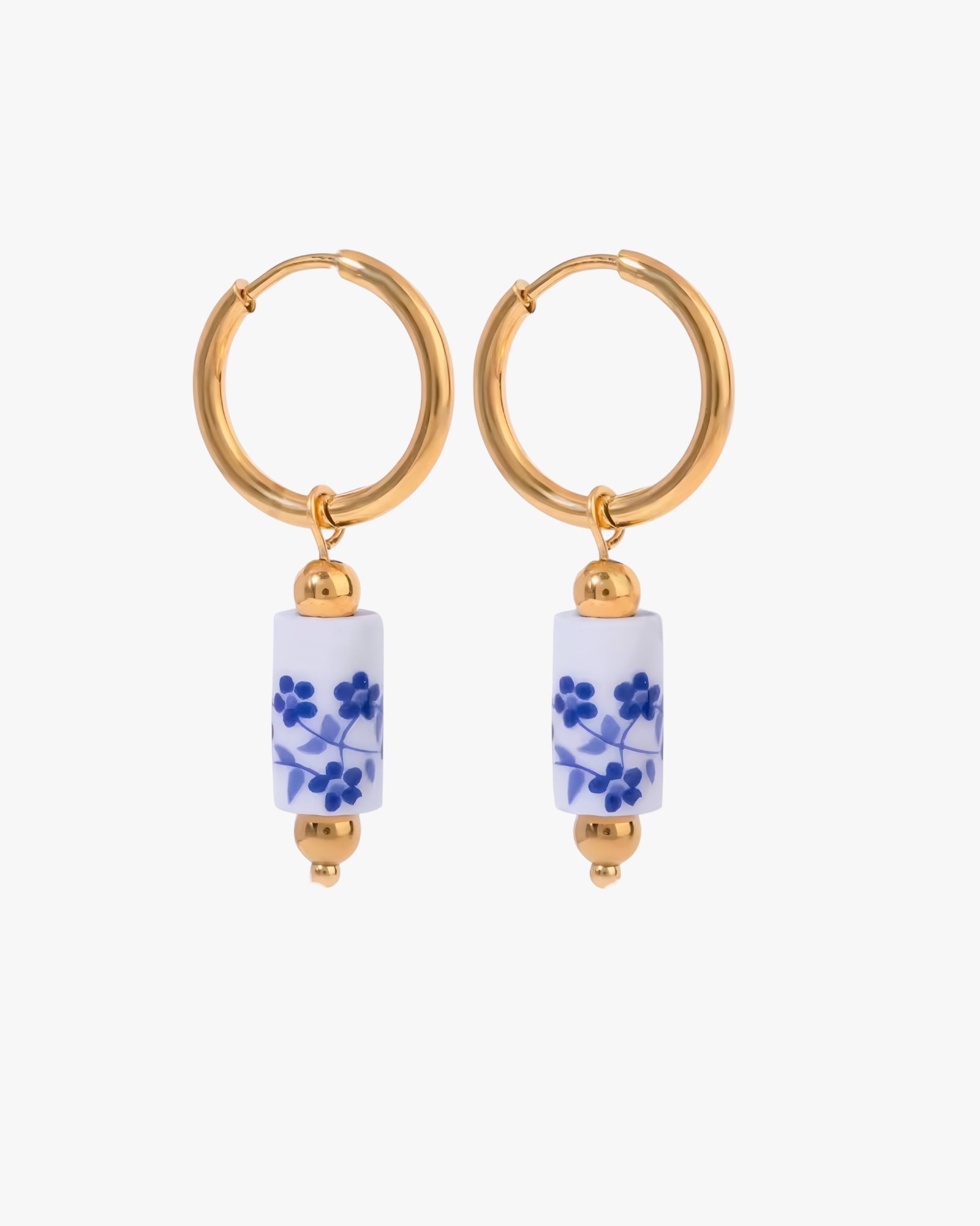 Gold hoop earrings with blue floral beads on a white background