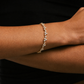 Bracelet on a wrist with a black background