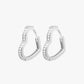 A pair of silver-colored hoop earrings with small, clear stones embedded along the hoop's length.
