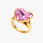 Gold ring with a pink heart-shaped gemstone on a white background